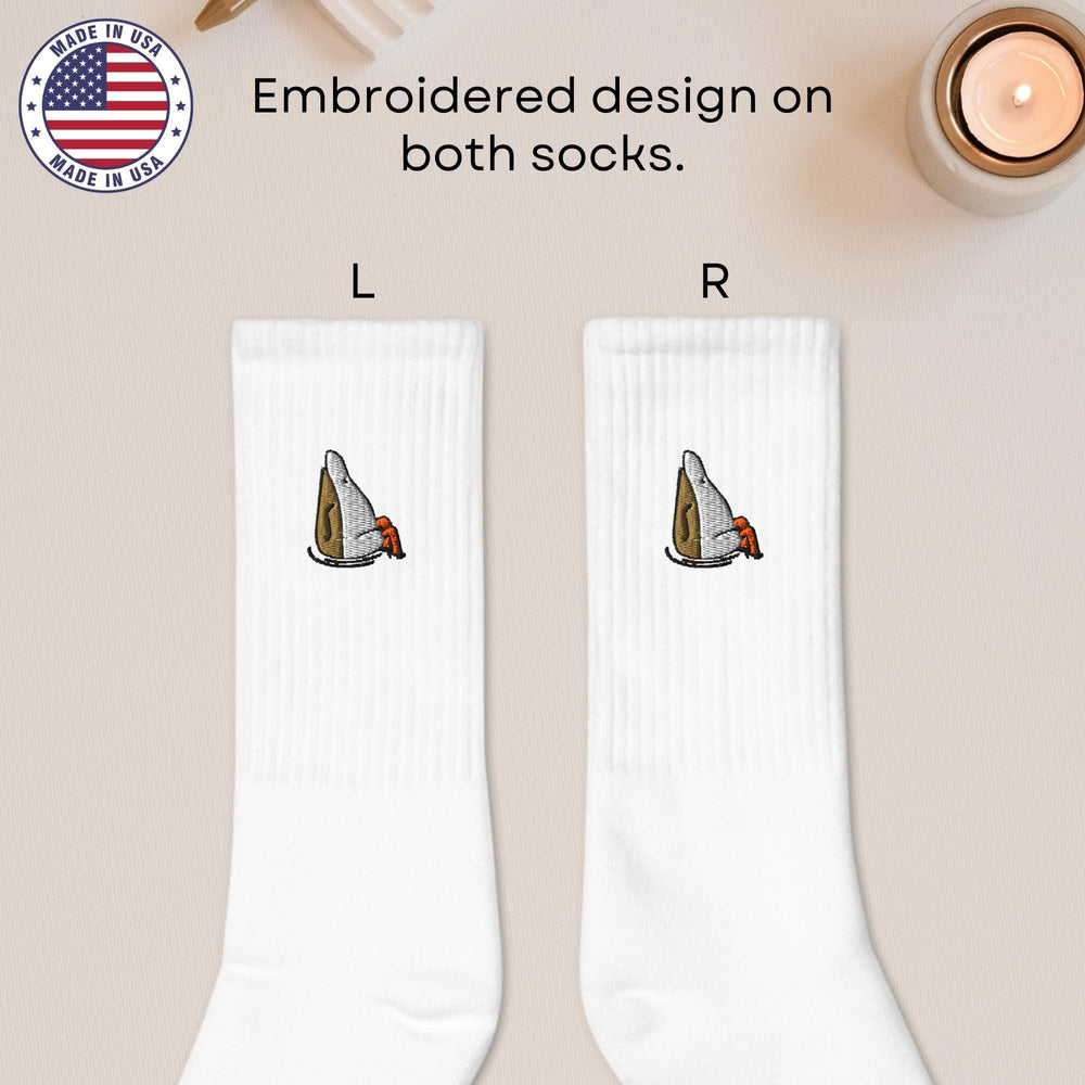 a pair of white socks with a picture of a knife