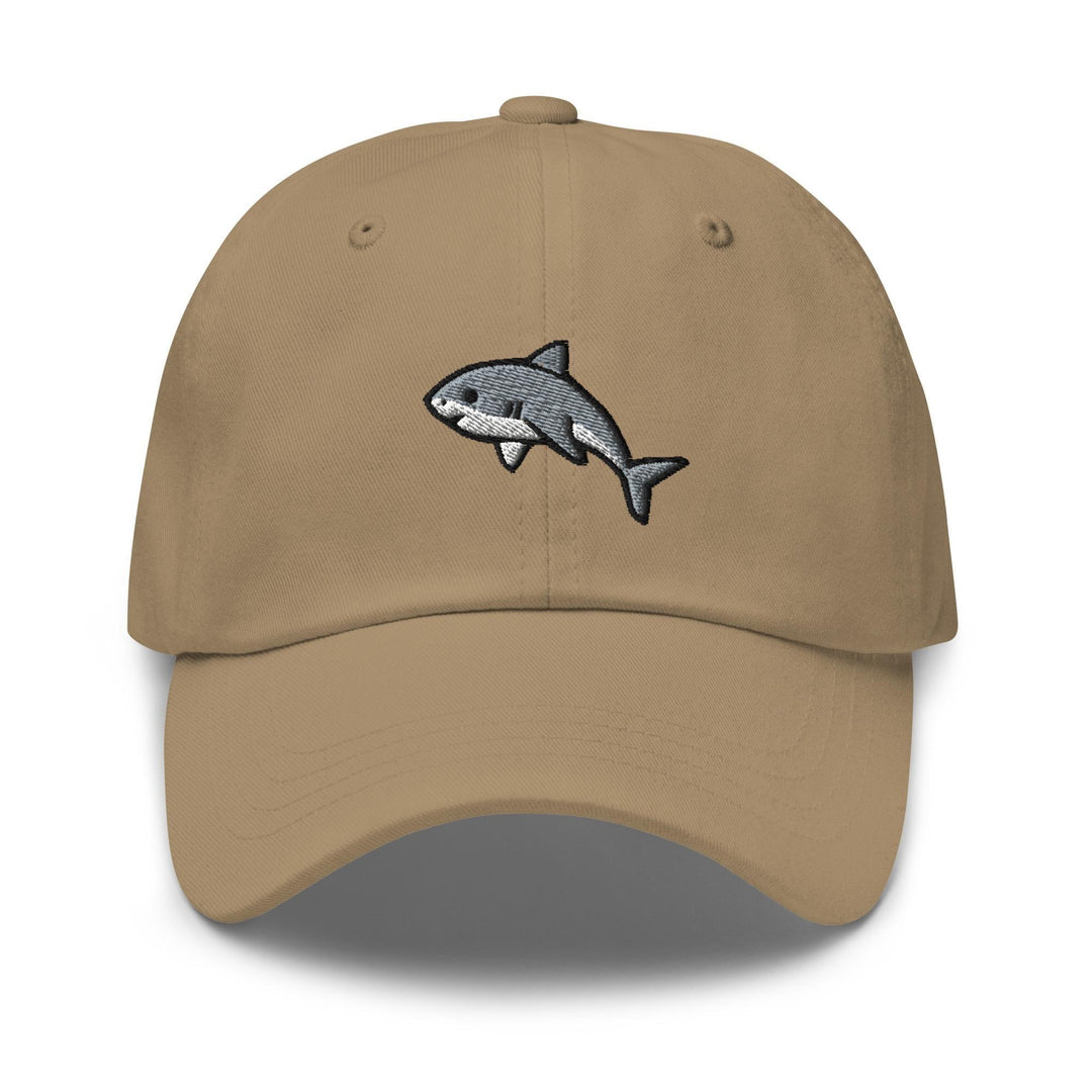 a tan hat with a shark embroidered on it