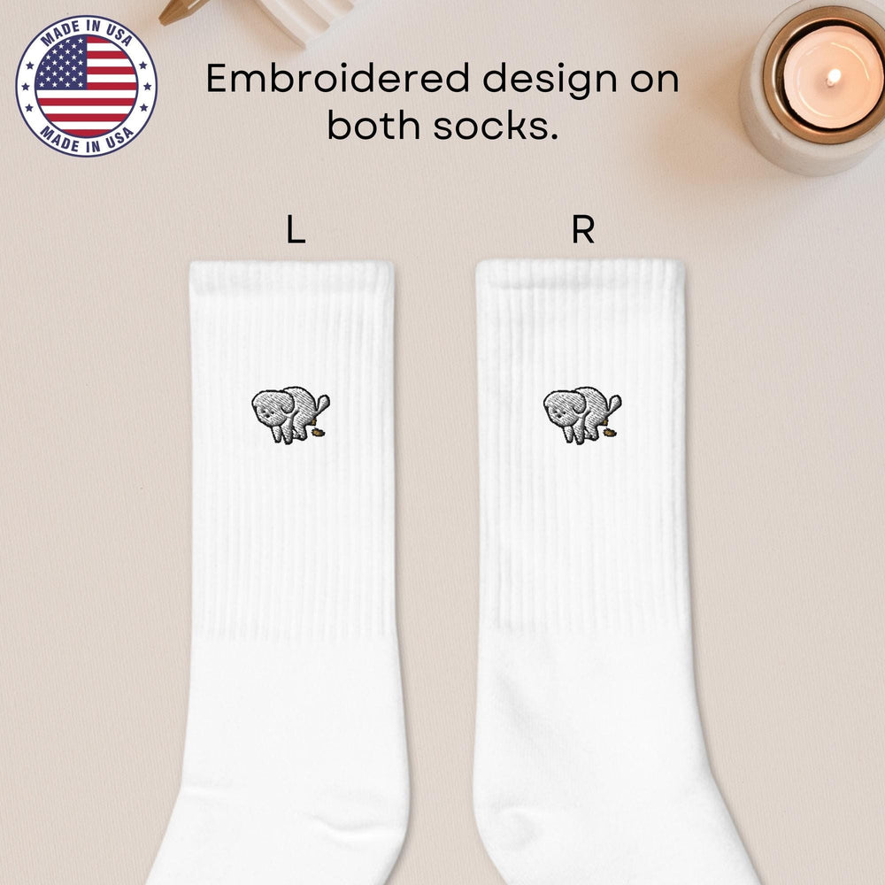 a pair of white socks with an elephant on them