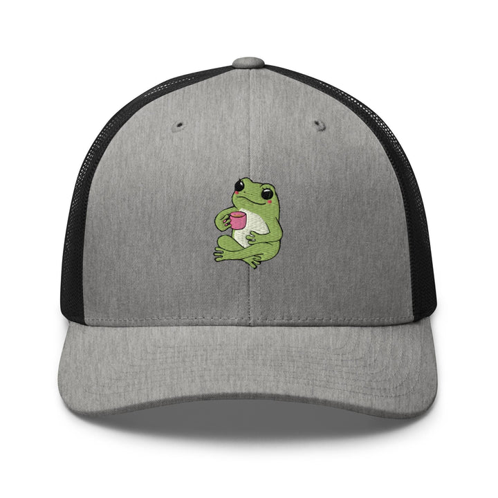 a gray and black trucker hat with a green frog eating a donut
