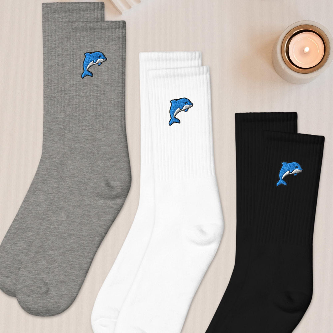 three pairs of socks with dolphins on them