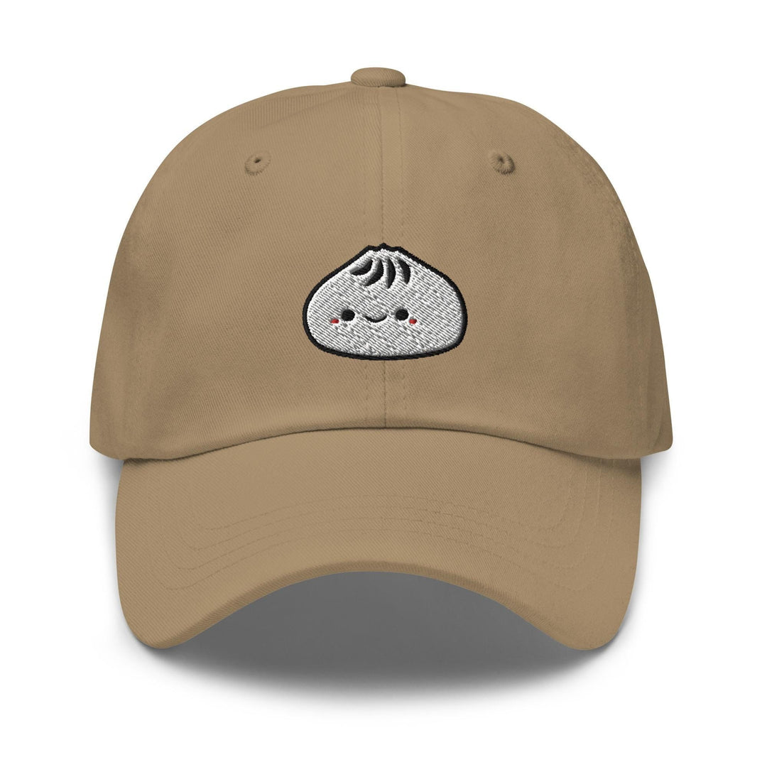 a khaki colored hat with a white rock embroidered on the front of it