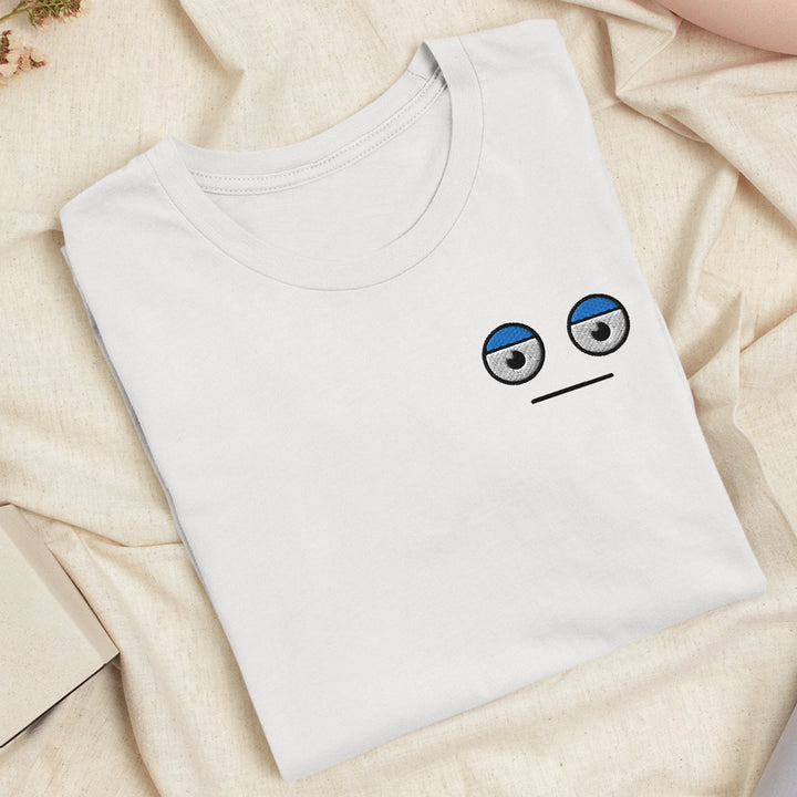 a t - shirt with a sad face drawn on it