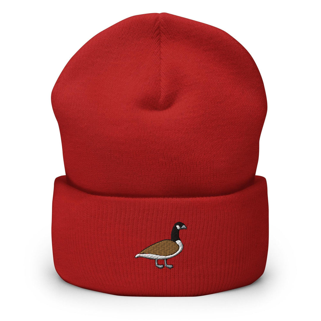 a red beanie with a bird embroidered on it