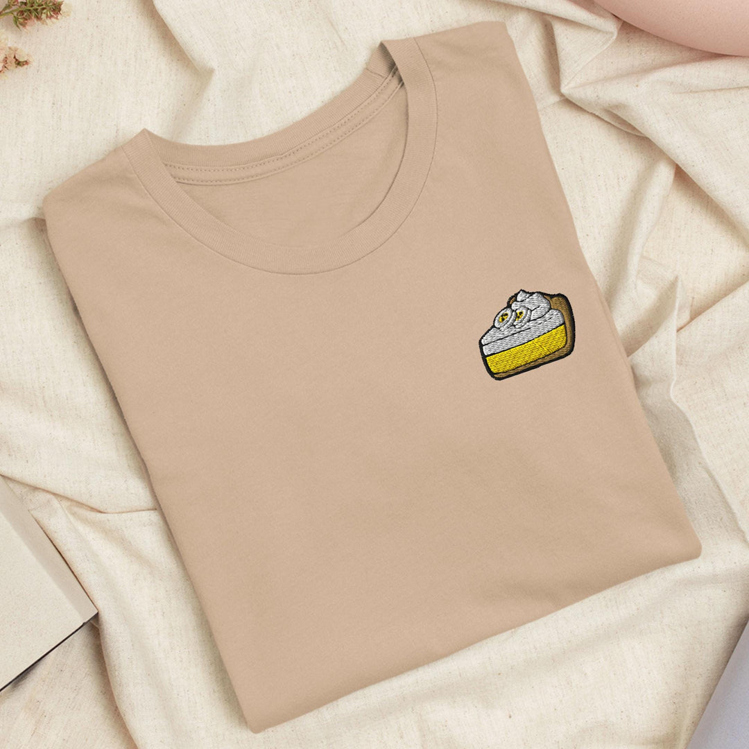 a t - shirt with a small piece of cake on it