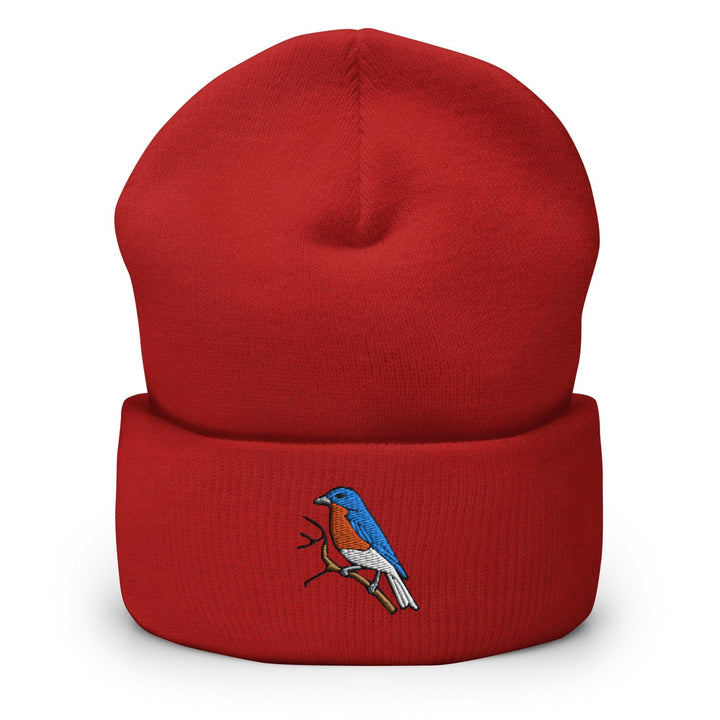 a red beanie with a blue bird on it