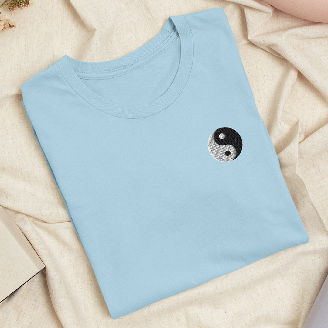 a blue t - shirt with a yin symbol on it