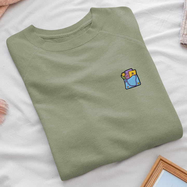a green t - shirt with a picture of a bird on it
