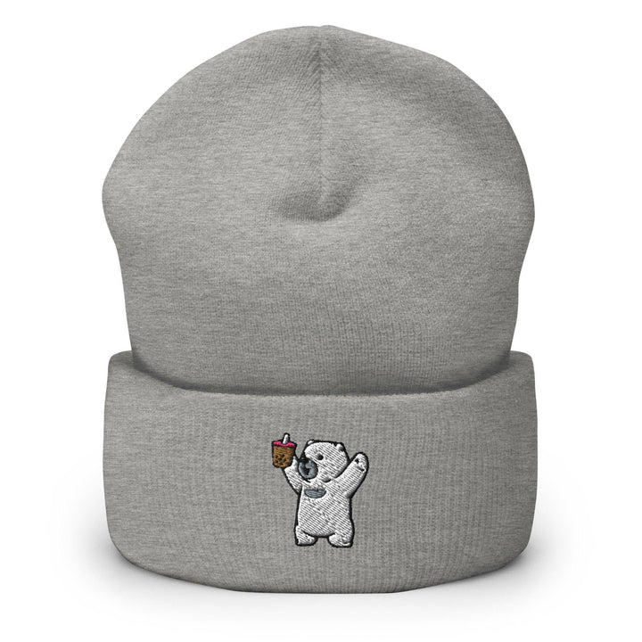 a grey beanie with a white bear holding a piece of cake