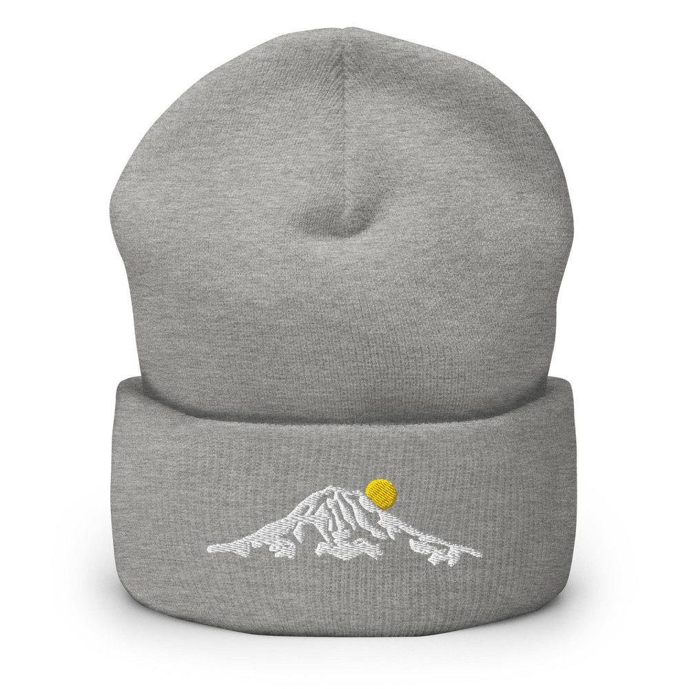 a grey beanie with a yellow ball on top of it