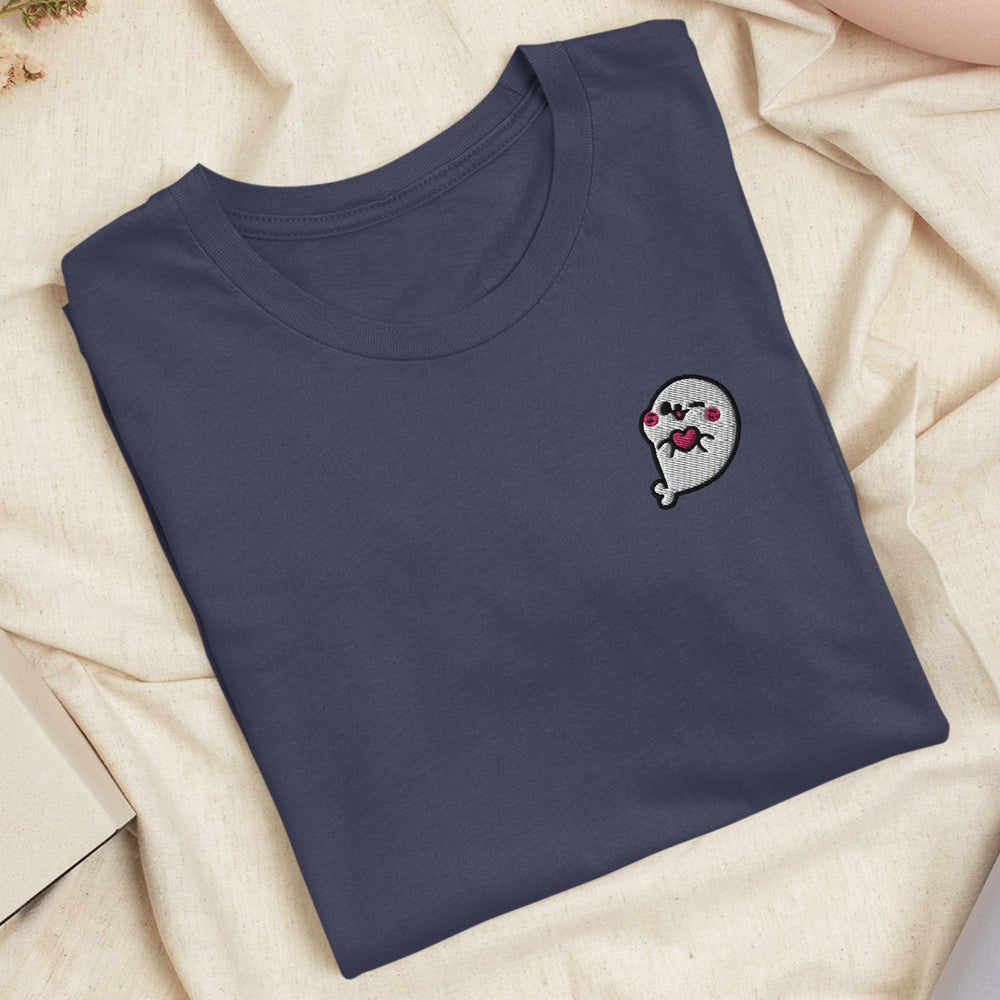 a blue t - shirt with a ghost embroidered on it