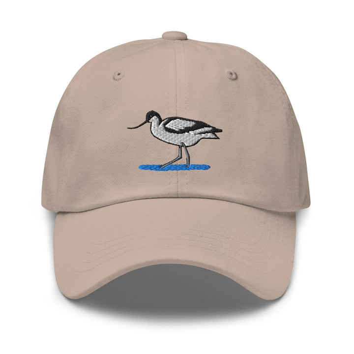a tan hat with a bird embroidered on it