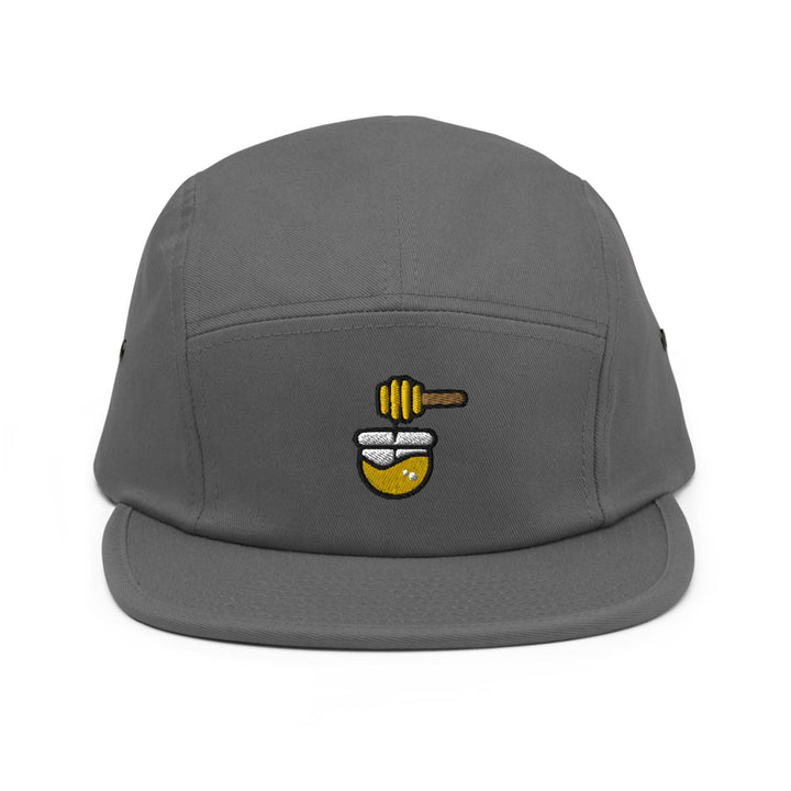 a grey hat with a bee on it