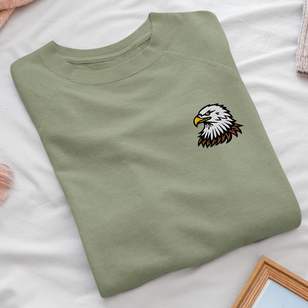 a green t - shirt with a bald eagle on it