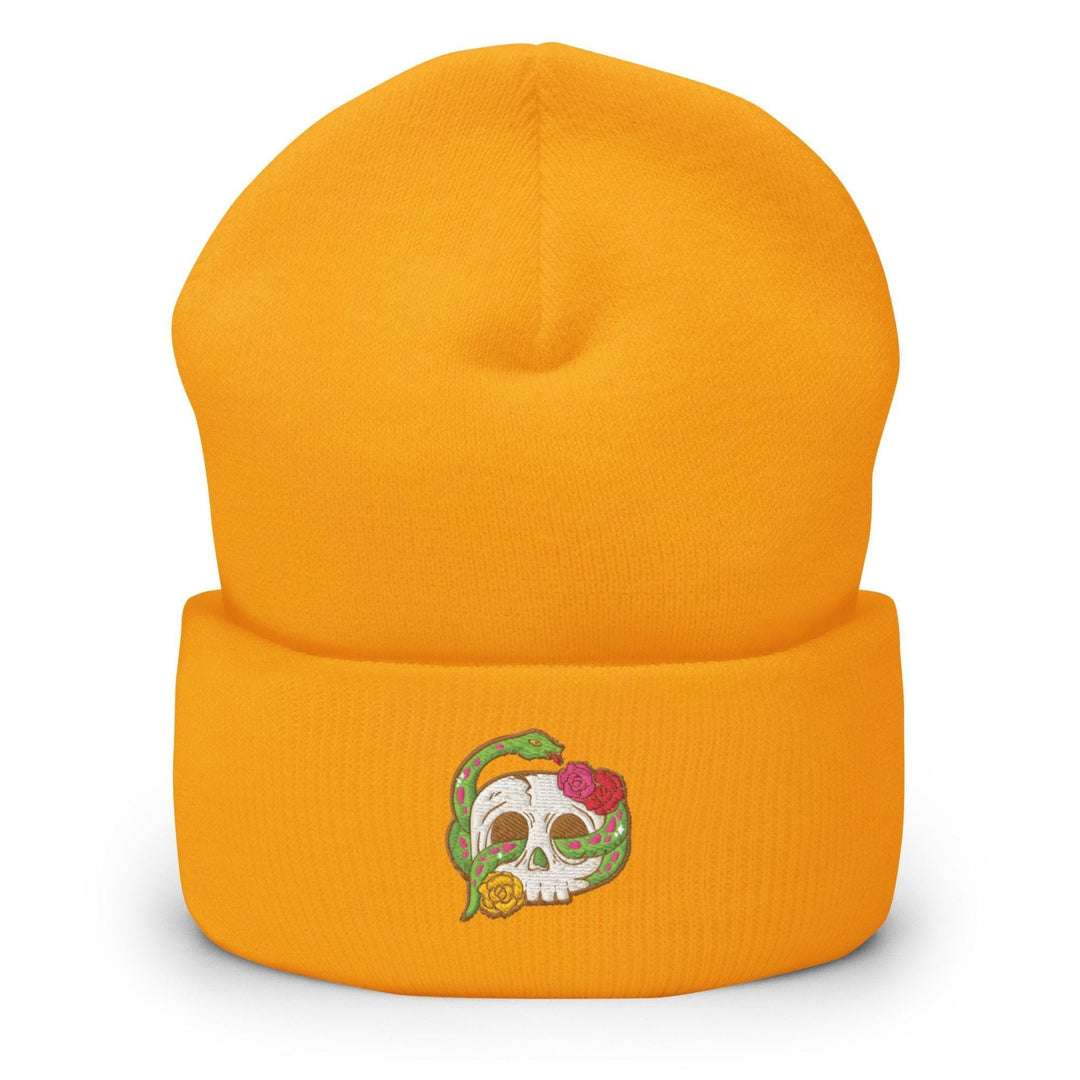 a yellow beanie with a skull on it