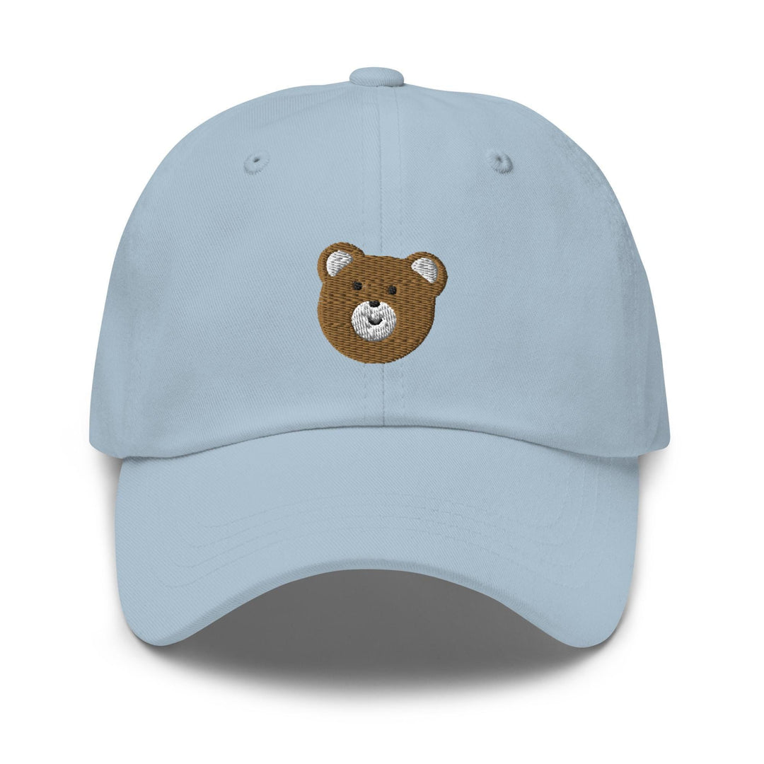 a light blue hat with a brown teddy bear embroidered on the front