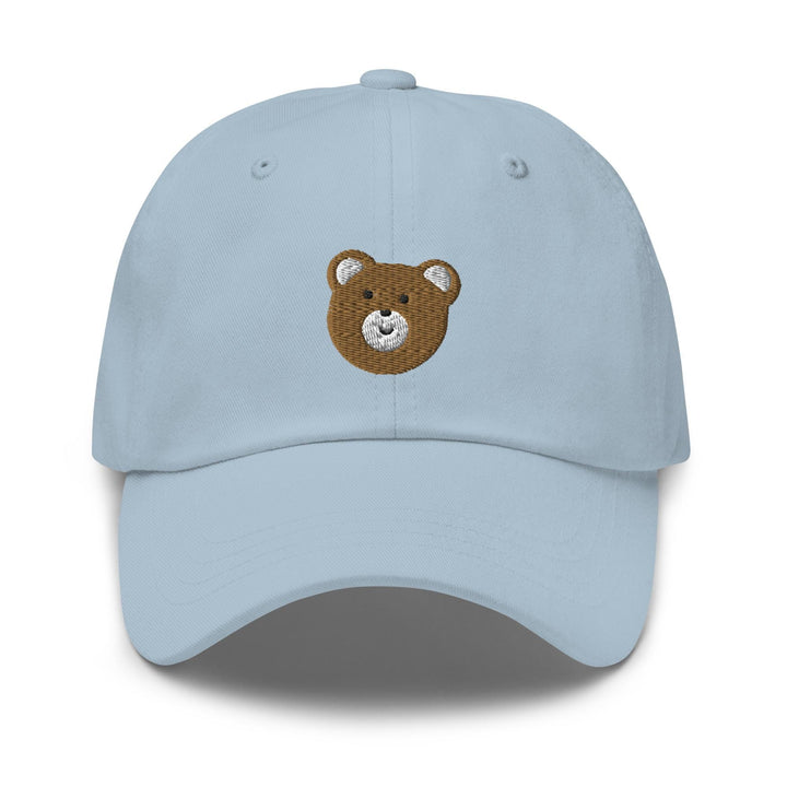 a light blue hat with a brown teddy bear embroidered on the front