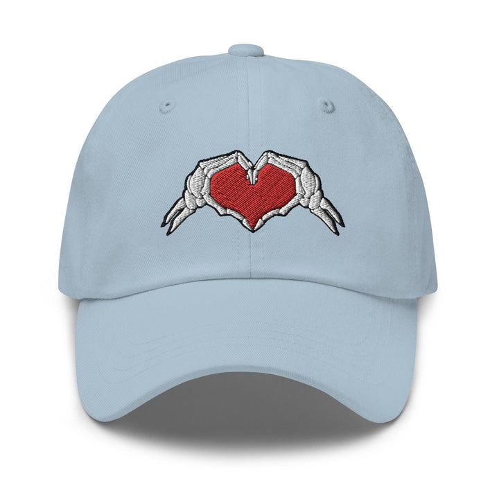 a light blue hat with two hands holding a heart