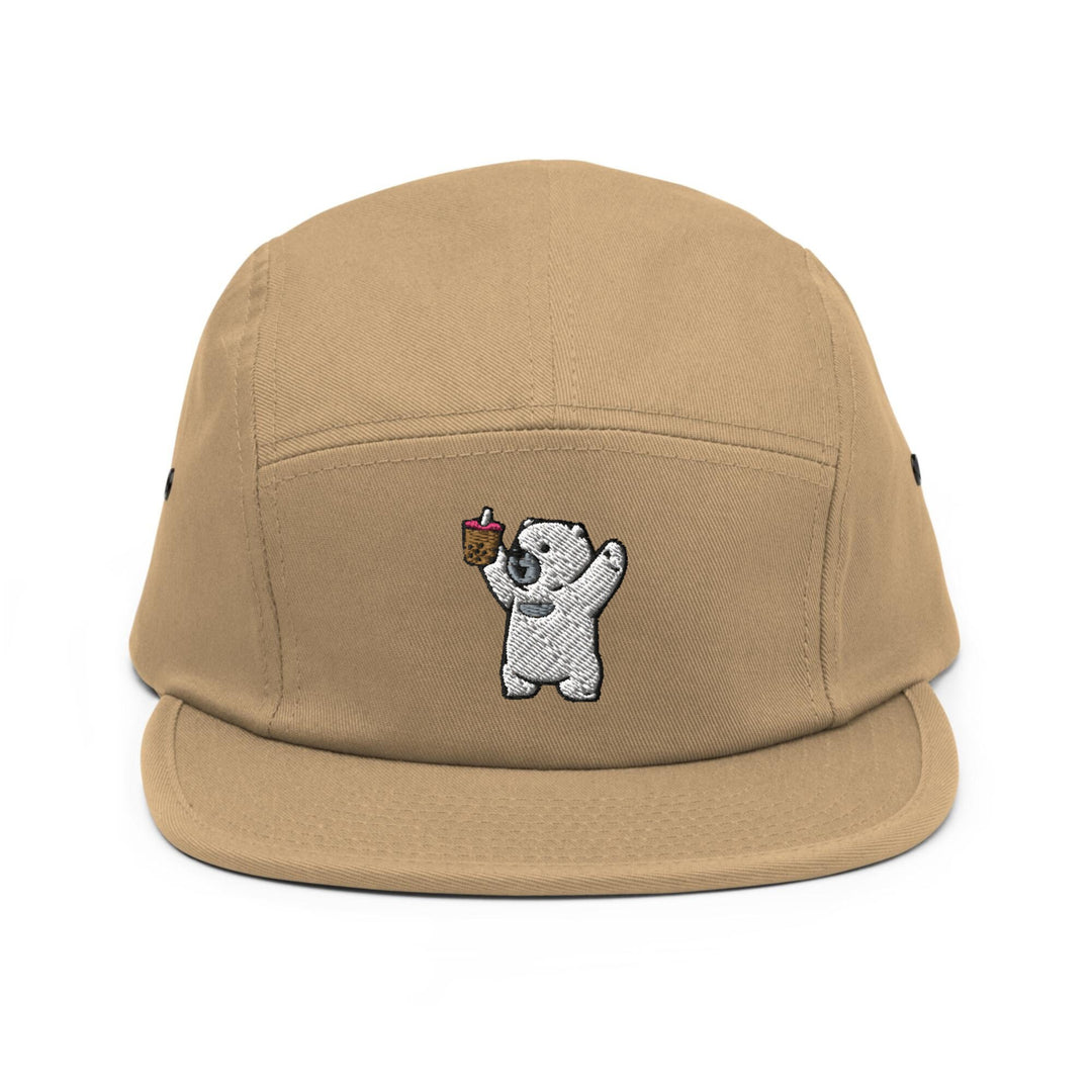 a brown hat with a bear holding a piece of cake