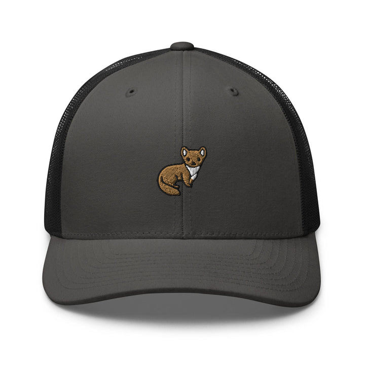 a gray and black trucker hat with a brown bear embroidered on the front