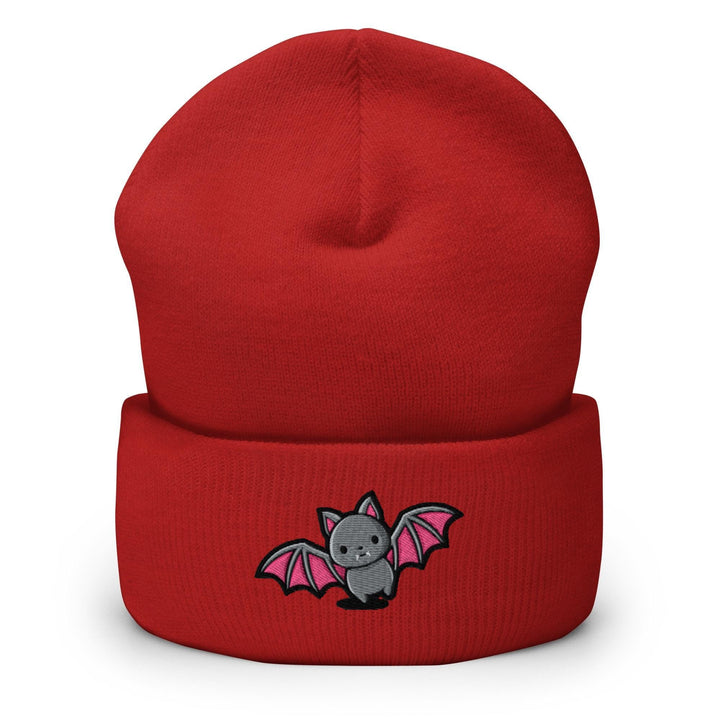 a red beanie with a bat embroidered on it