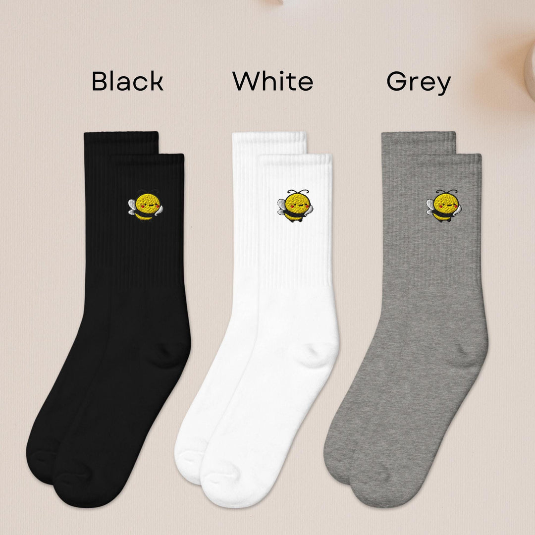 three pairs of black, white, and grey socks