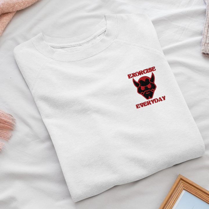 a white t - shirt with a black dog on it