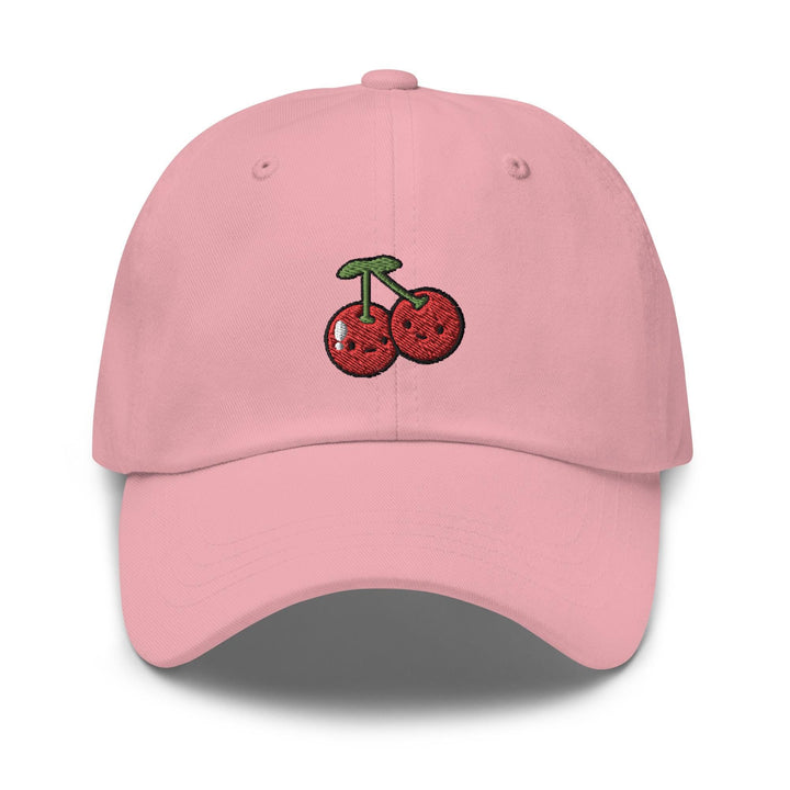 a pink hat with cherries embroidered on it