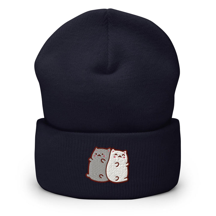 a black hat with two cats on it