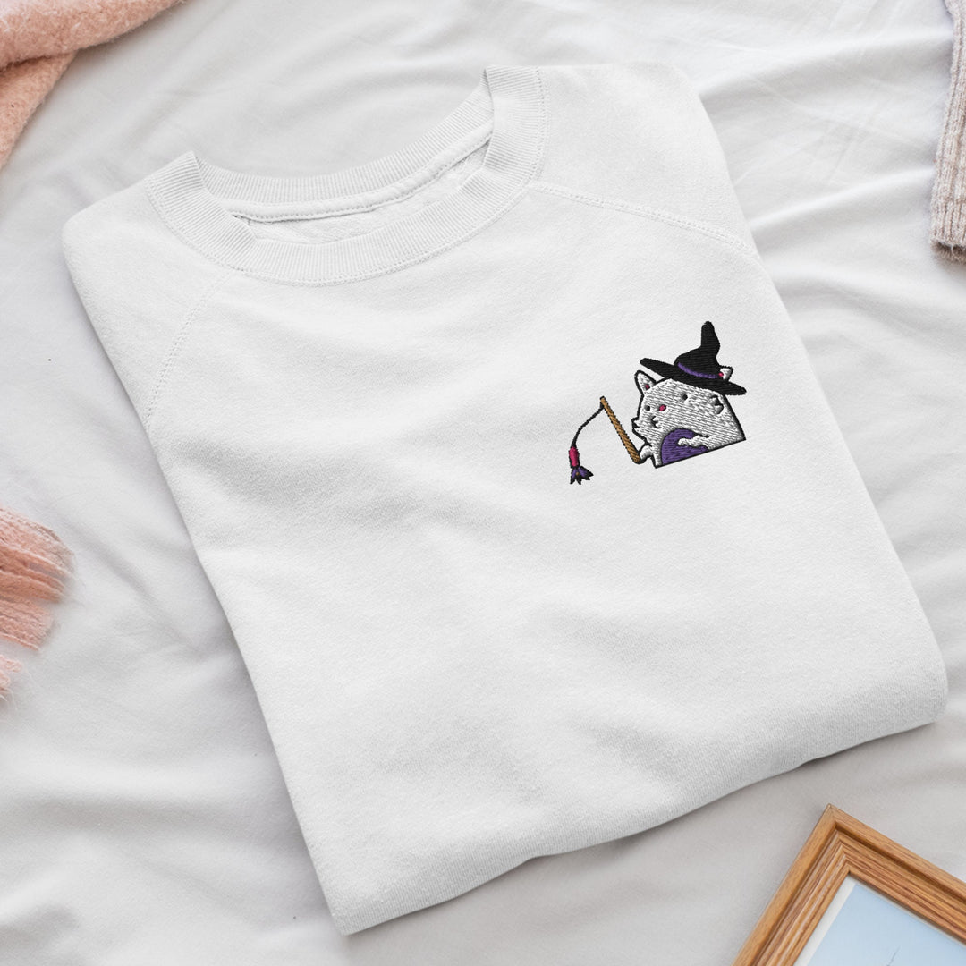 a white t - shirt with a picture of a witch on it