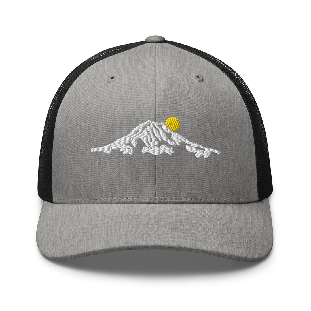 a gray and black trucker hat with a yellow ball on it