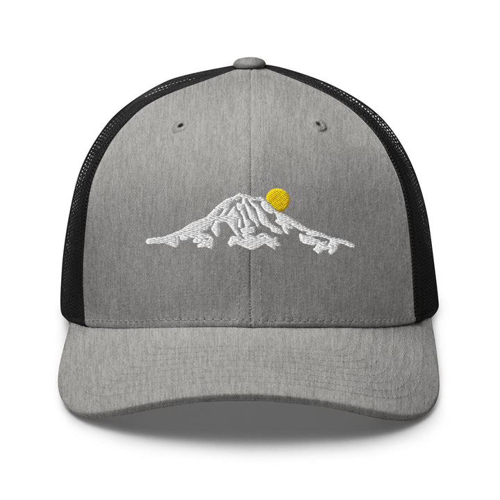 a gray and black trucker hat with a yellow ball on it