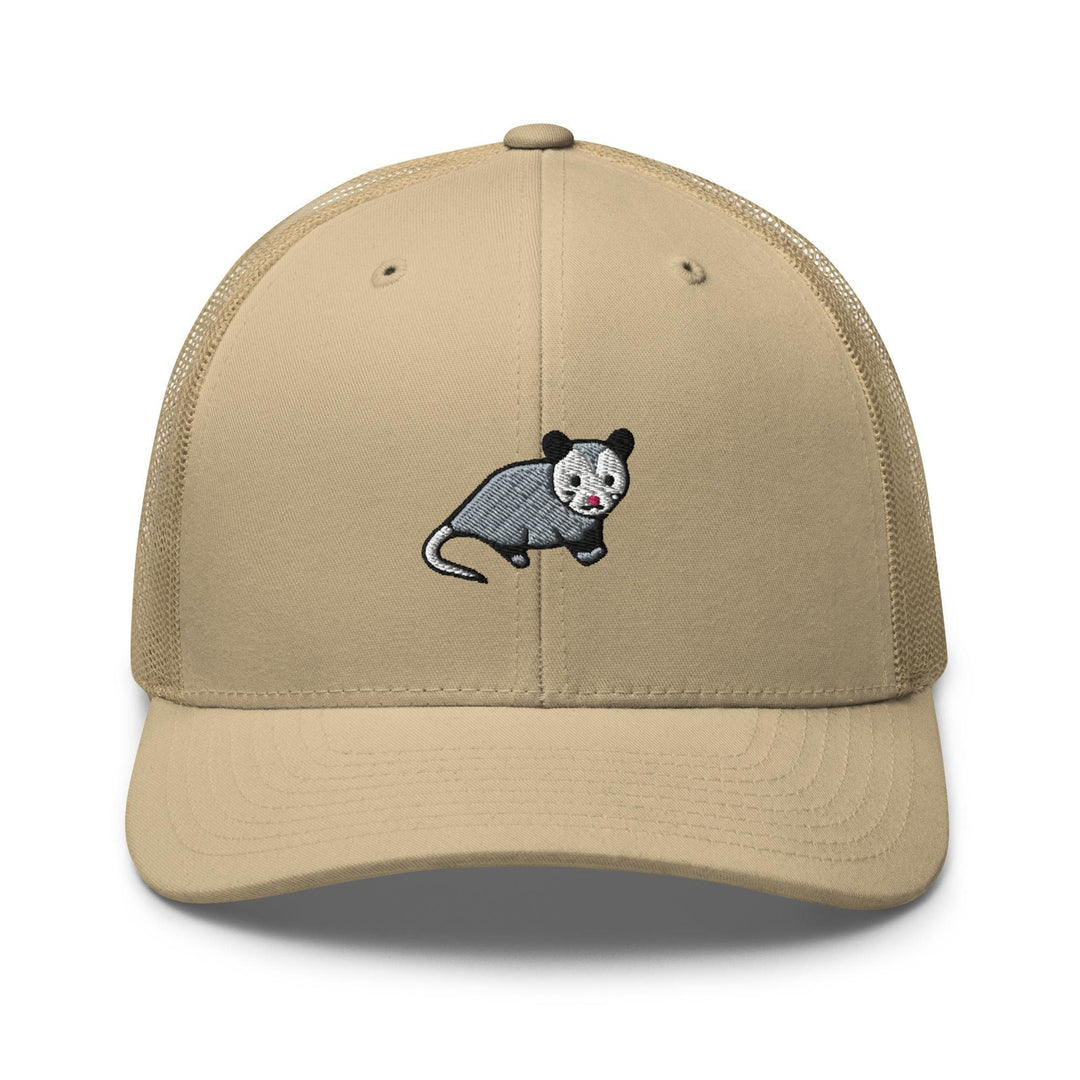 a tan hat with a black and white rat on it