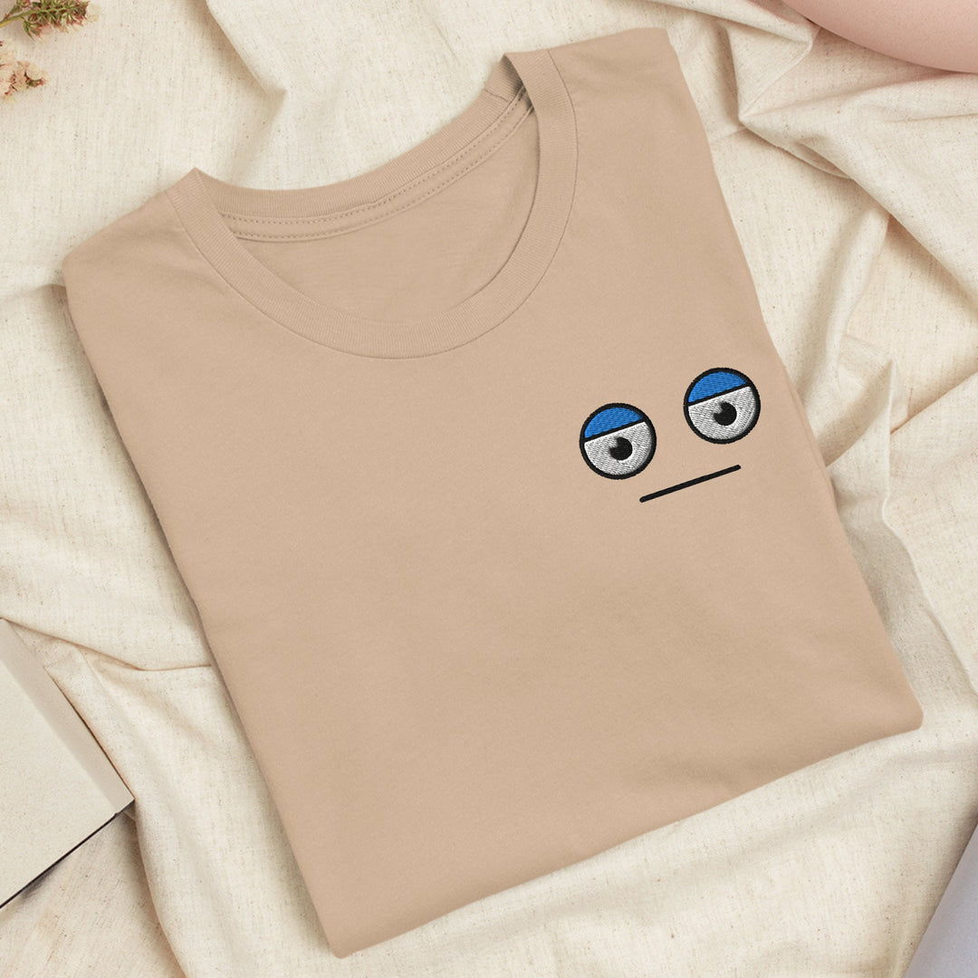 a t - shirt with a sad face drawn on it