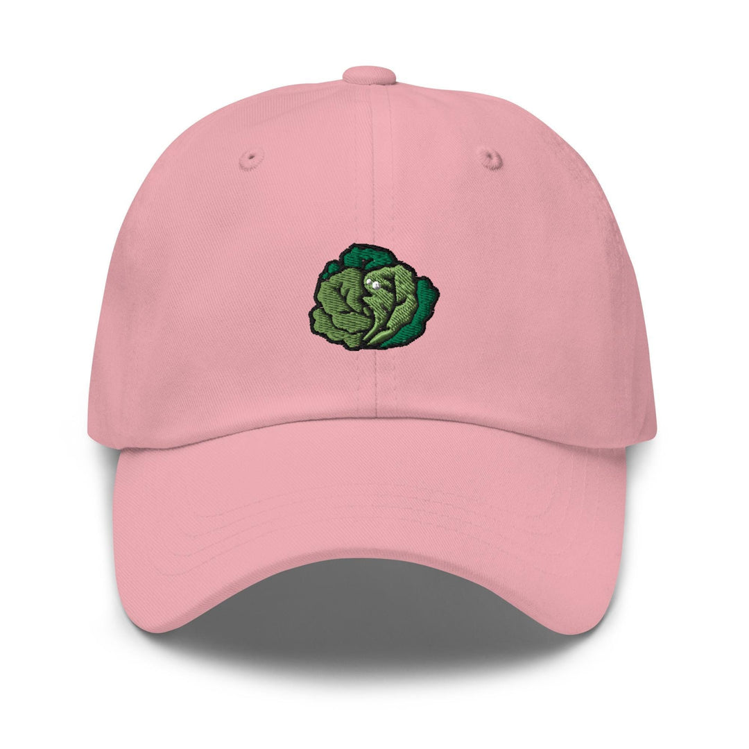a pink hat with a green leaf embroidered on it