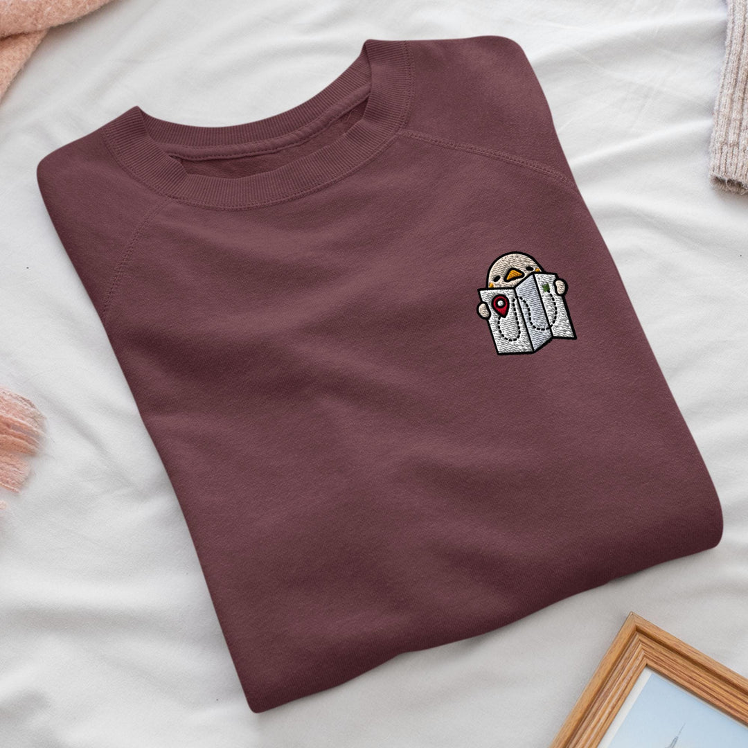 a t - shirt with a sticker on it sitting on a bed