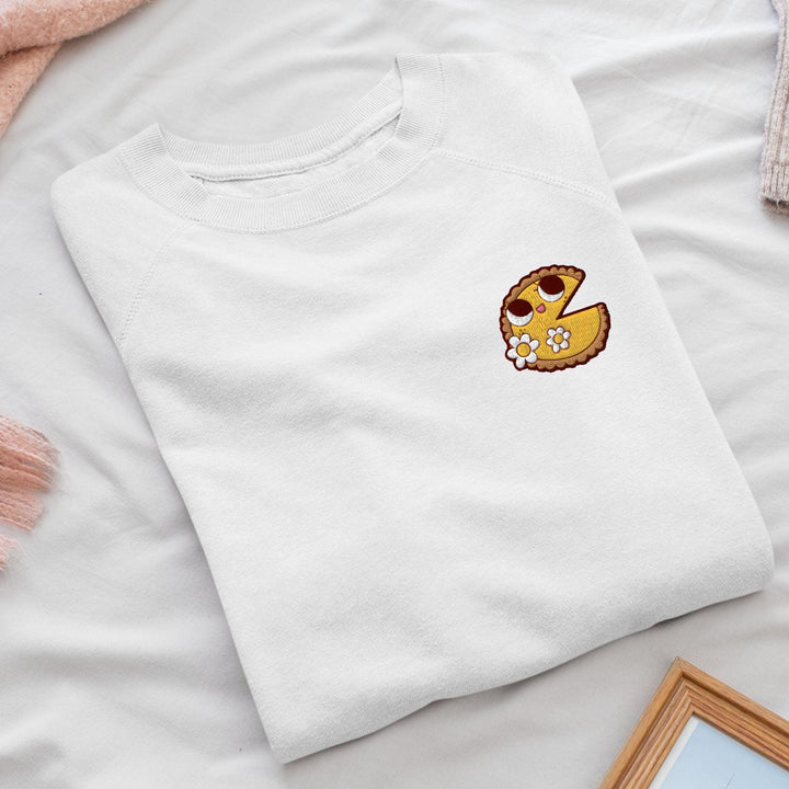 a white t - shirt with a yellow smiley face on it