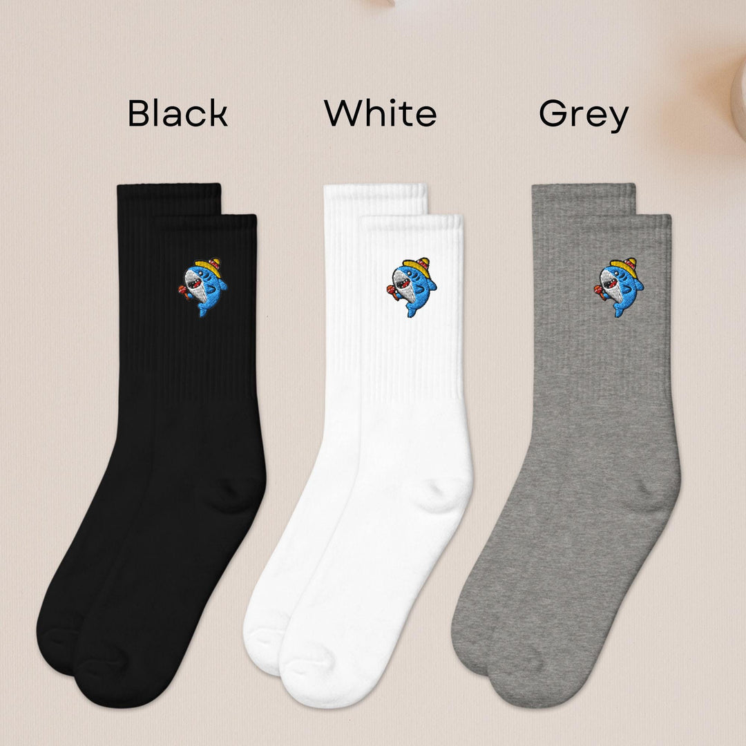 three pairs of black, white, and grey socks