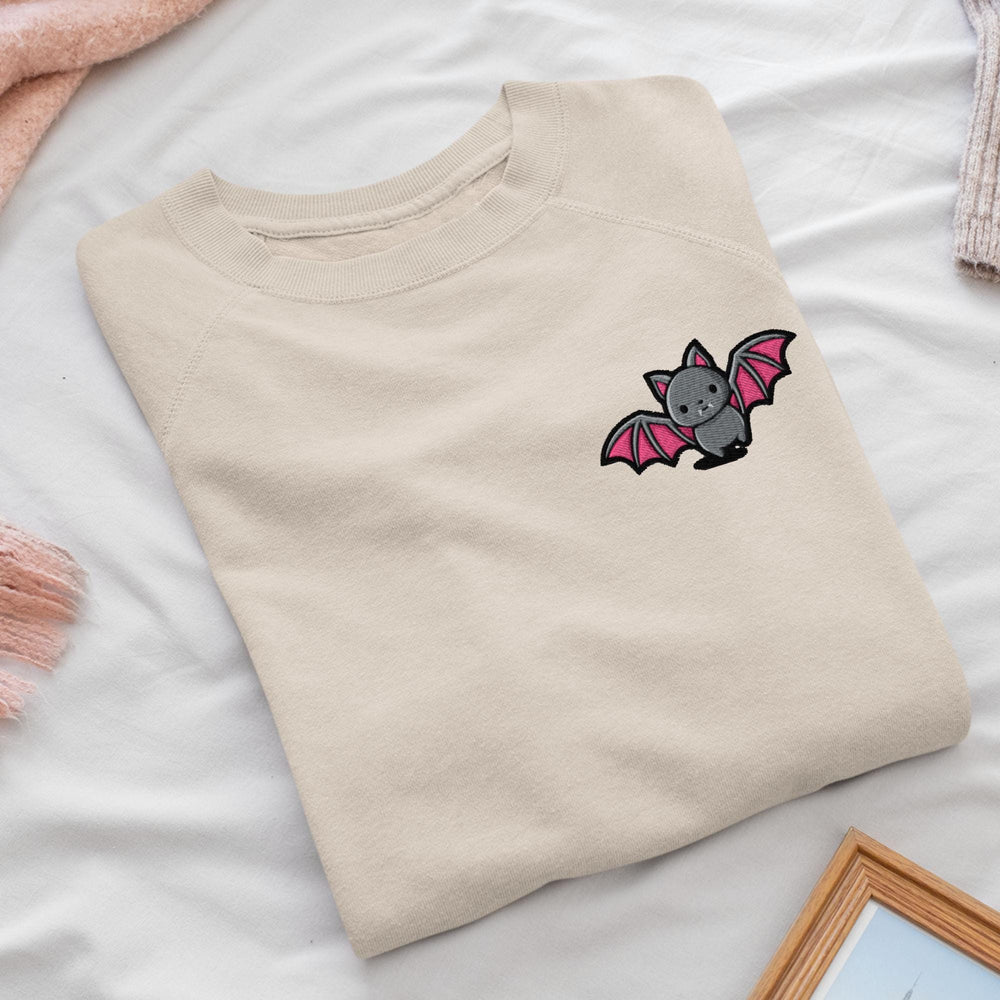 a t - shirt with a bat embroidered on it