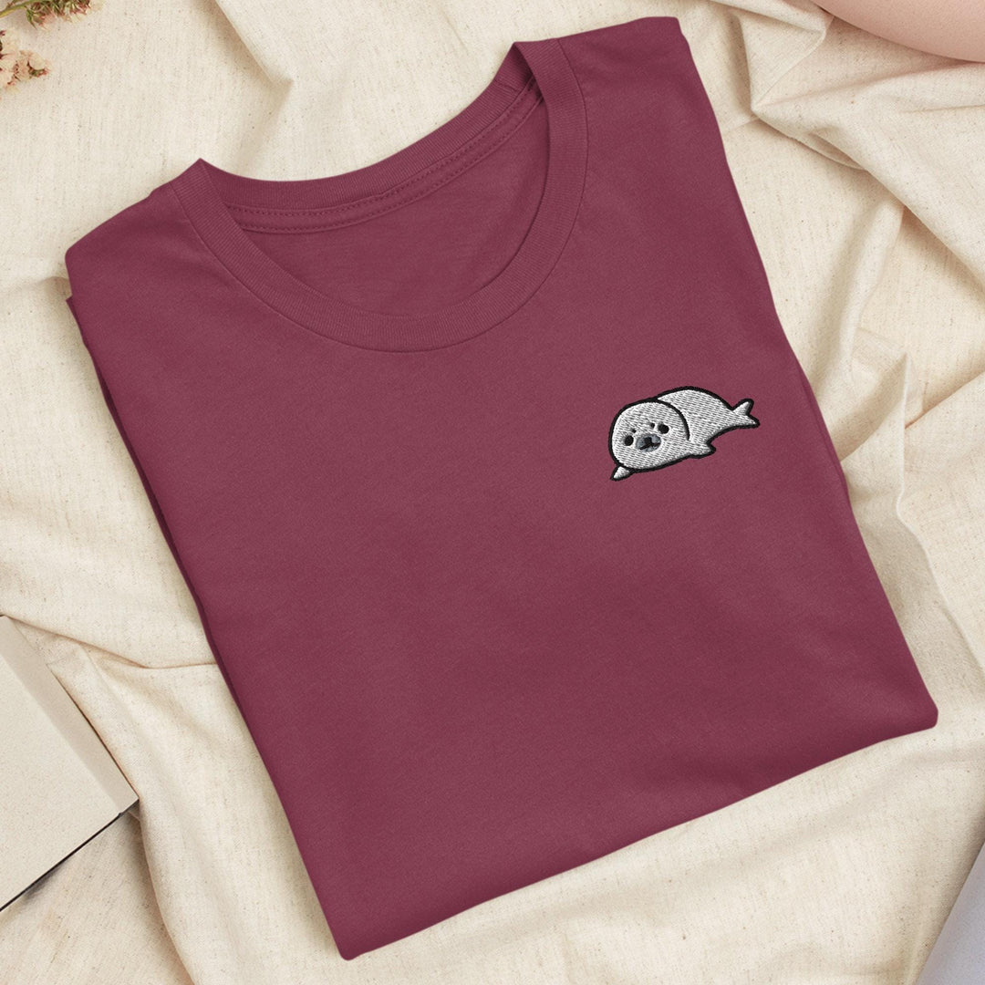 a t - shirt with a ghost on it laying on a bed