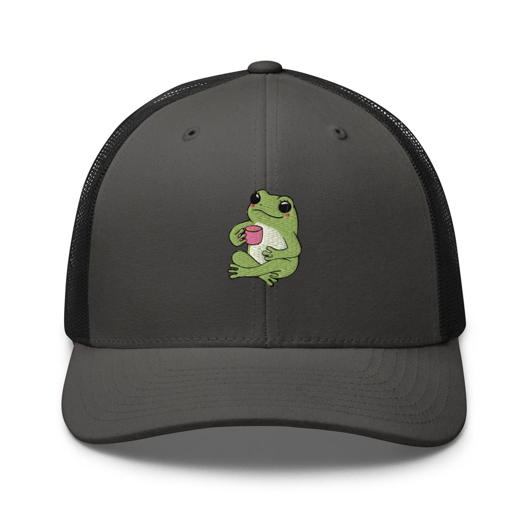 a gray and black trucker hat with a green frog holding a cup of coffee