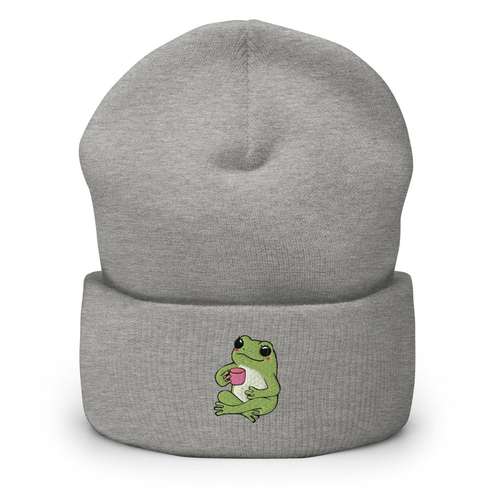 a gray beanie with a green frog on it