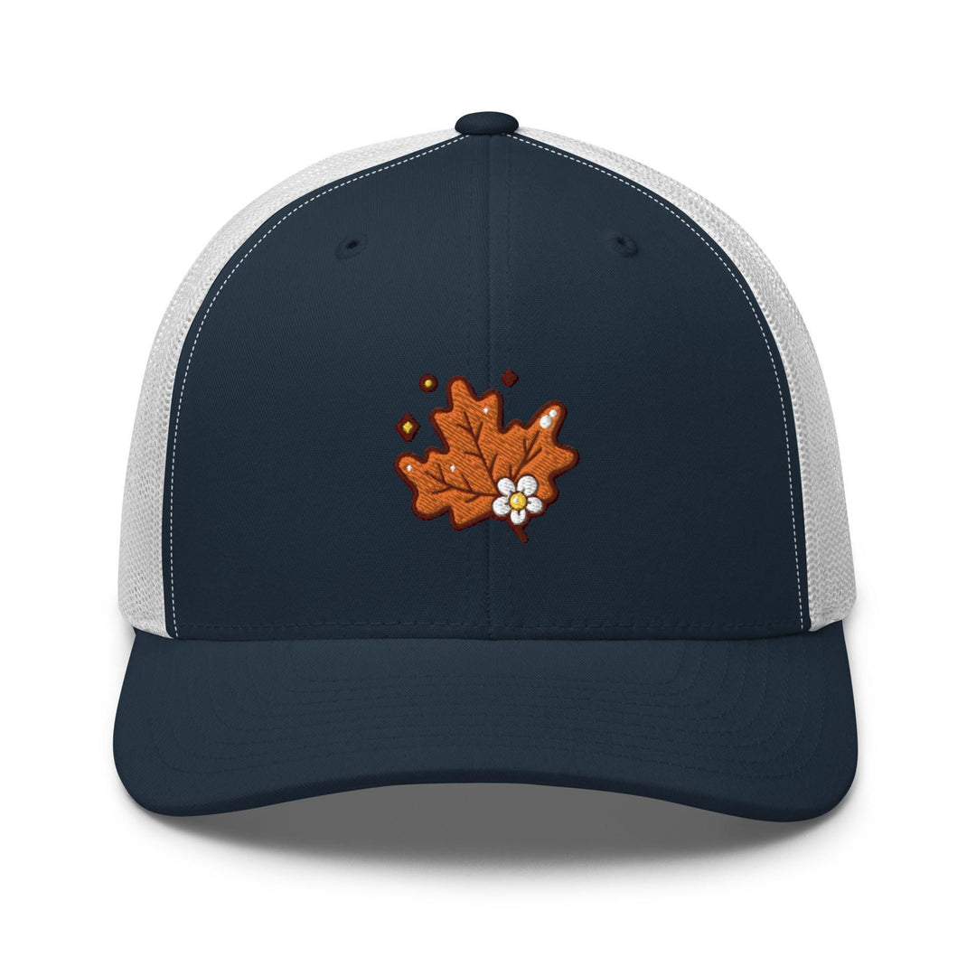 a blue and white trucker hat with an orange maple leaf embroidered on the front