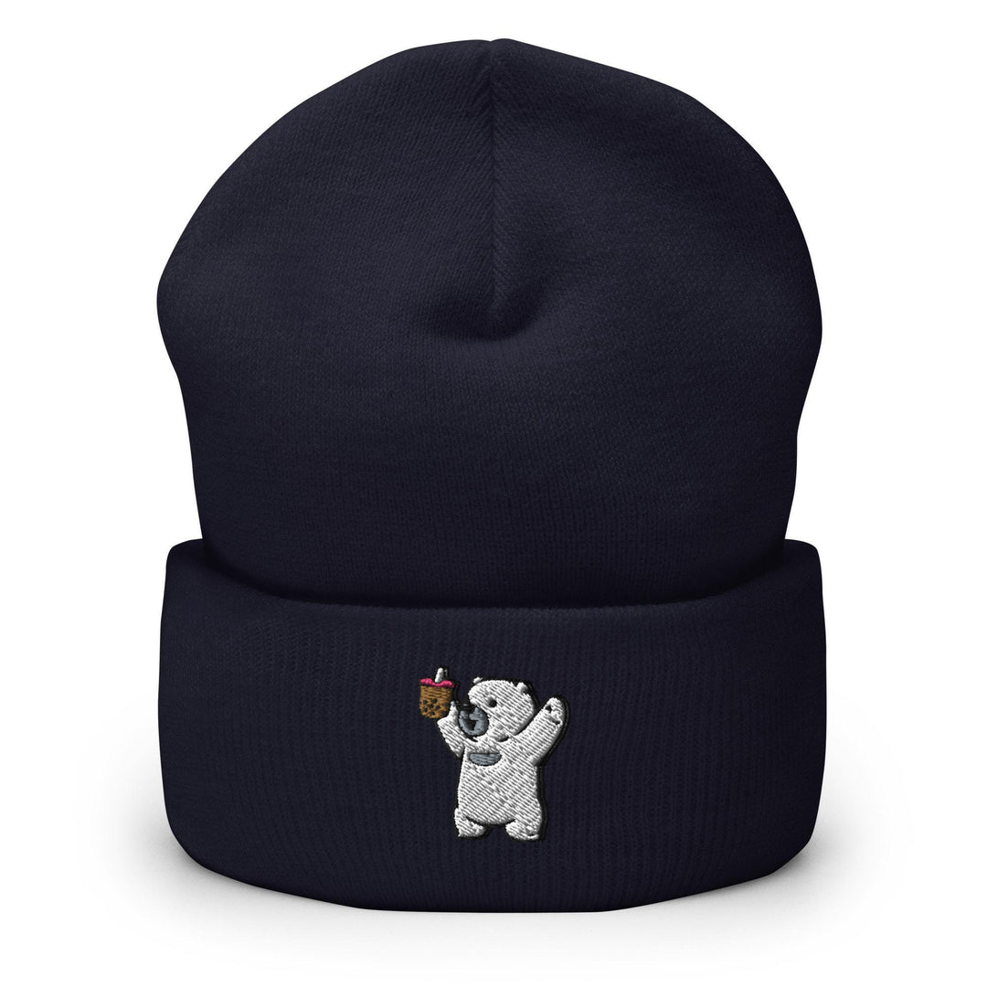 a black beanie with a white bear holding an apple