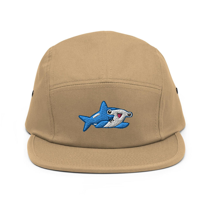 a tan hat with a shark embroidered on it