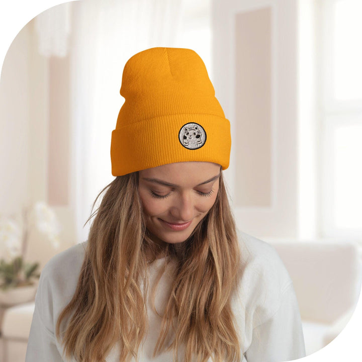 a woman wearing a beanie looking at her cell phone