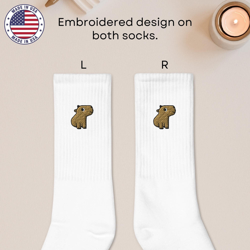 a pair of white socks with a brown dog on it