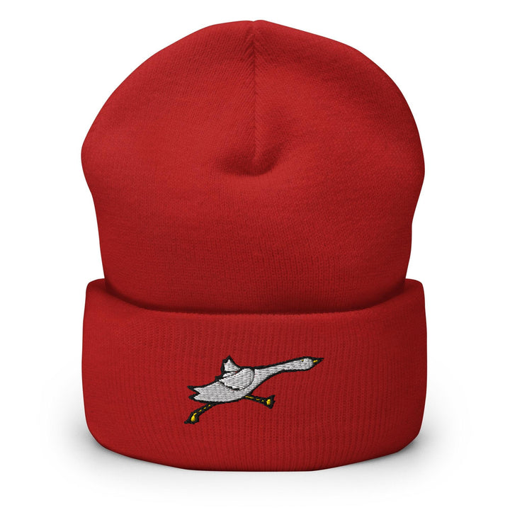 a red hat with a white bird on it