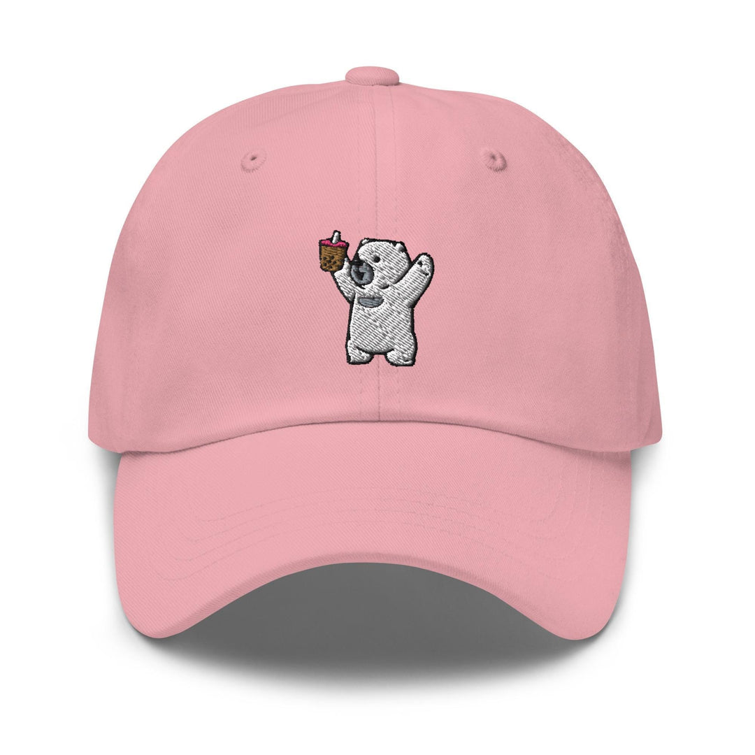 a pink hat with a koala holding a piece of cake