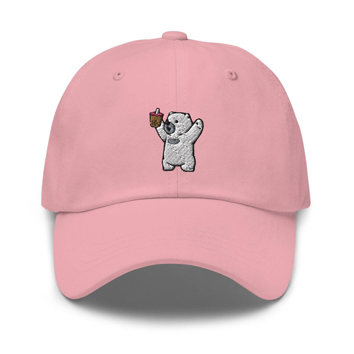 a pink hat with a koala holding a piece of cake